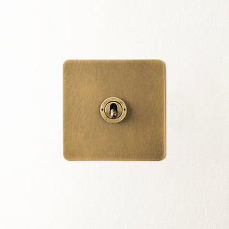 Lucian one gang intermediate toggle switch in aged brass