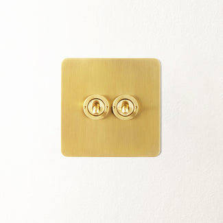 Lucian two gang intermediate toggle switch in top brass