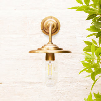 Peewit IP44 wall light in antique brass